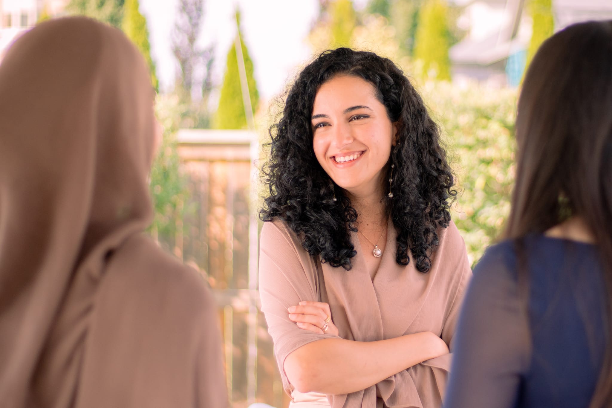 Yasmien speaking with two clients